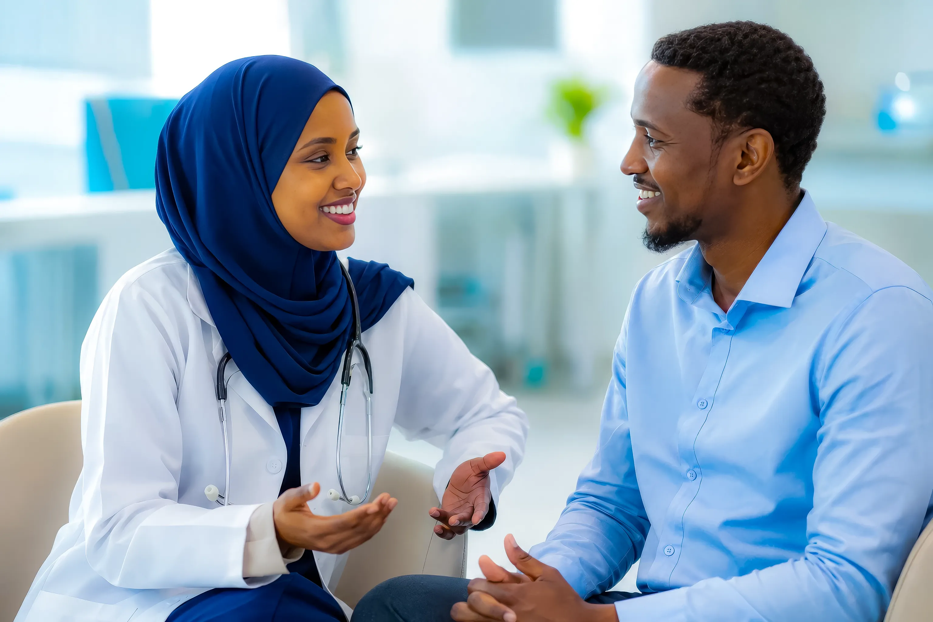 Illustrative campaign photograph of a Somali clinician listening to a smiling patient