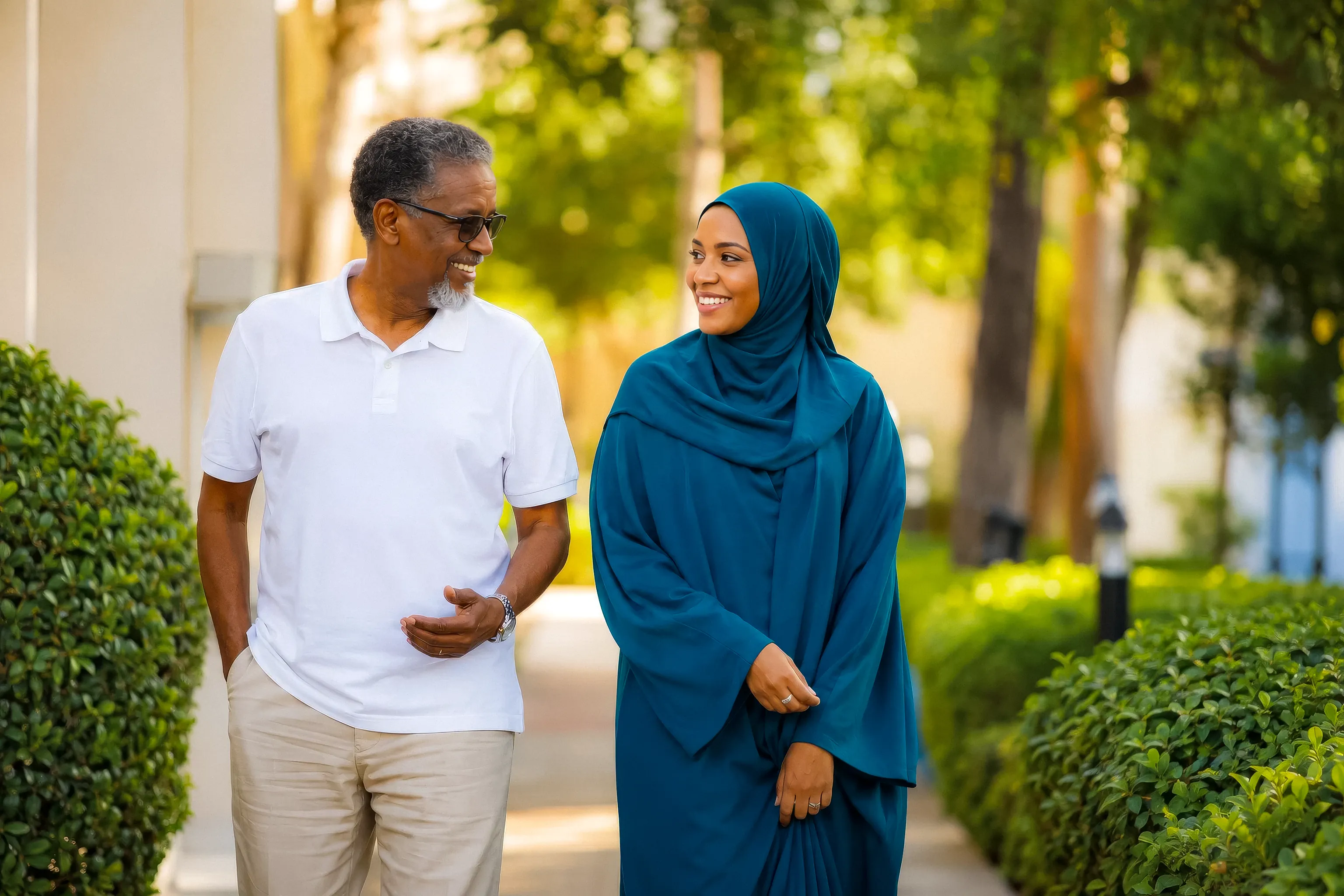 Illustrative campaign photograph of a Somali father and daughter enjoying a garden walk